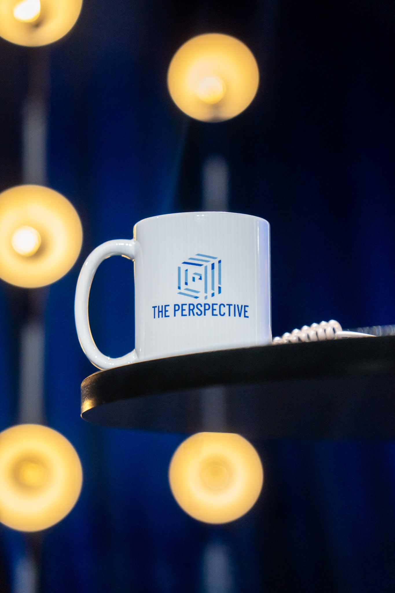 Branded mug among warm studio bokeh