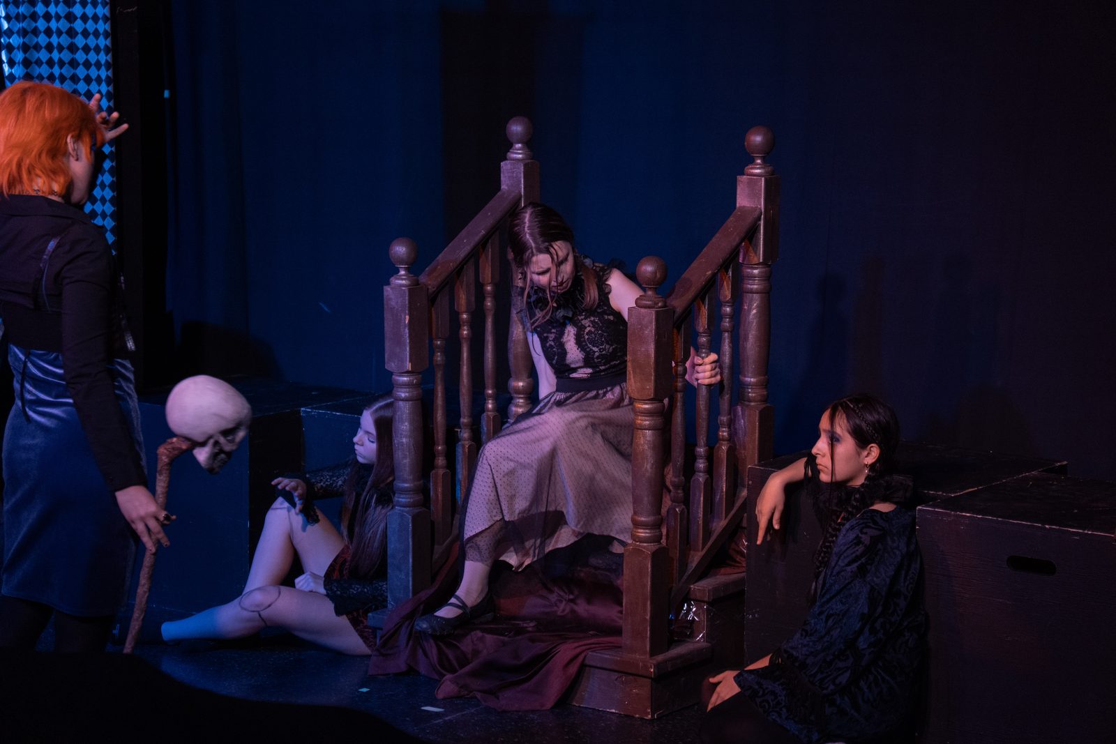 Theatre cast in a moody, dramatically lit scene