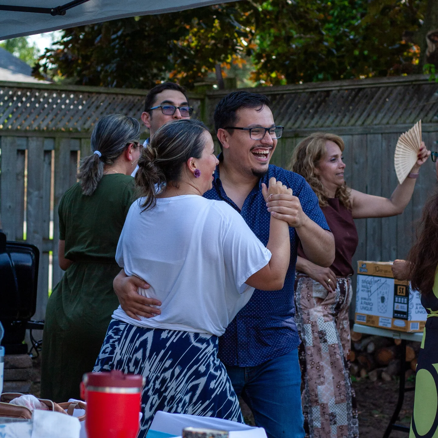 Guests embracing at an outdoor party